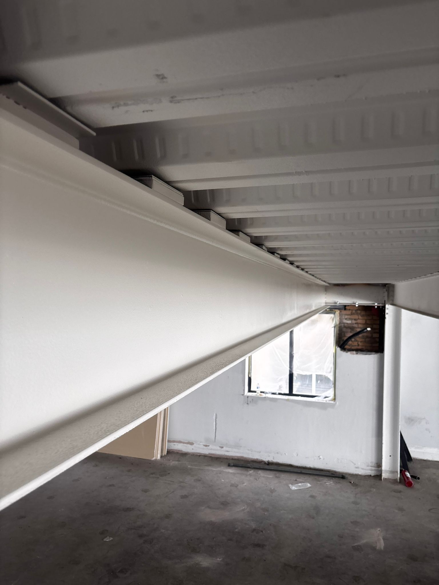 Applying the intumescent base coat to steel beams